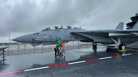 Craig Ceccanti and his kids in front of the F-14 Tomcat flown in the original Top Gun
